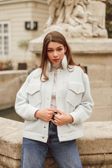 Young woman wearing stylish trendy bomber jacket. Casual outfit. Street style fashion
