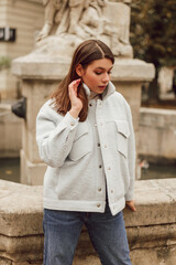 Young woman wearing stylish trendy bomber jacket. Casual outfit. Street style fashion