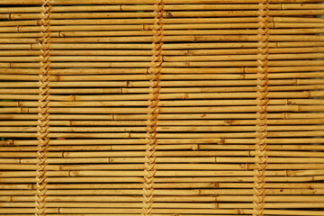 Wall of bamboo. The texture of bamboo. The stems are tightly woven.