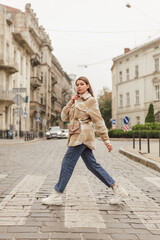 Young woman wearing stylish trendy plaid shirt. Casual outfit. Street style fashion