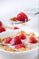 breakfast with brown rice flakes, milk and fresh raspberries