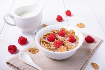 breakfast with brown rice flakes, milk and fresh raspberries