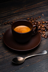 on the rustic wooden background, tasty and creamy Italian espresso in the cup