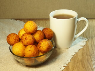 Beautiful breakfast. Freshly made donuts. Cottage cheese balls with a cup of tea.