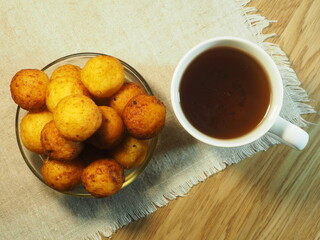 Cottage cheese balls with a cup of tea. Beautiful breakfast. Freshly made donuts. View from the top.