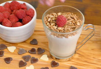 white yogurt with honet, cereal grain and fresh raspberries