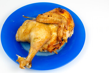 part of fried chicken on a ceramic dish close-up