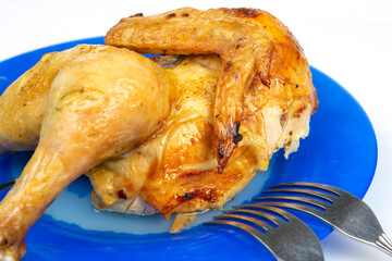 part of fried chicken on a ceramic dish close-up