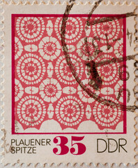 GERMANY, DDR - CIRCA 1974 : a postage stamp from Germany, GDR showing  a red pattern in Plauen lace