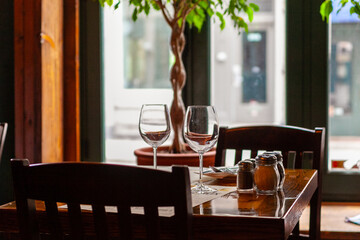 A table for two in a restaurant in Montreal, Quebec, Canada, against light from outside