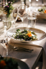 Close up of table setting of  salad with edible flowers