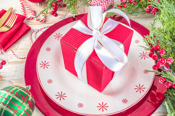 Christmas or New Year table setting. Place setting for Christmas Dinner. On wooden background with Holiday Decorations