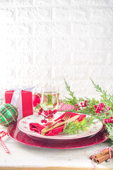 Christmas or New Year table setting. Place setting for Christmas Dinner. On wooden background with Holiday Decorations