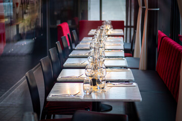 Row of empty restaurant tables with chairs