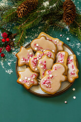 Christmas baking. Homemade gingerbread cookies with glaze on the Tidewater Green countertop. Color trend background 2021. Copy space.