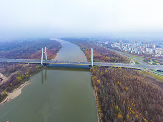 Aerial drone view. bridge  in the rays of a sunny morning. Autumn haze in the air, cars are driving...