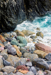 Lava, marble, and granite breakwater in Monterosso al Mare, Italy, 2017.