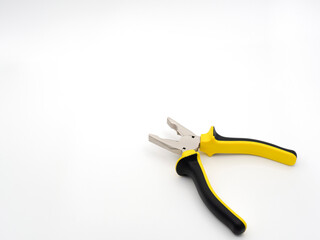 Fototapeta premium Black and yellow pliers on a white background. The disclosed pliers.
