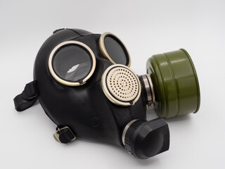 Black rubber gas mask with green filter on the left. Protection from radiation and gases.