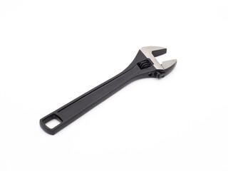 Black open adjustable wrench on a light background