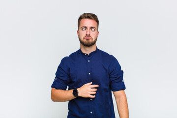 young man looking goofy and funny with a silly cross-eyed expression, joking and fooling around