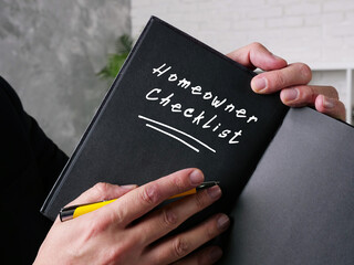 Business concept meaning Homeowner Checklist with phrase on the sheet.