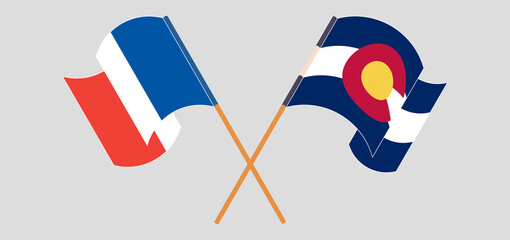 Crossed and waving flags of France and The State of Colorado