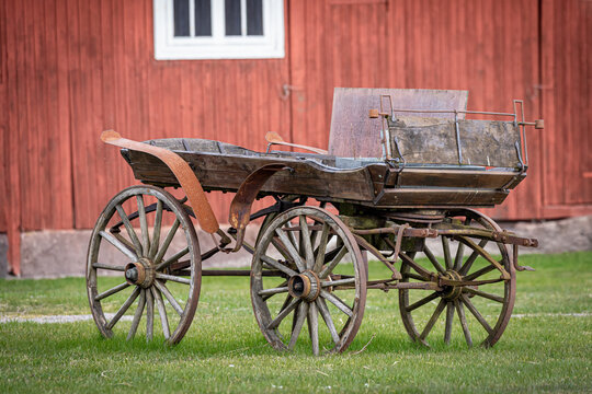 Image of the old wooden horse cart on the grass 