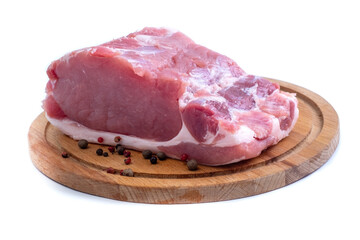 Fresh piece of pork on a wooden board and white background. Isolation on a white background. Close-up.