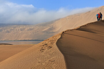 Fototapeta na wymiar Tourists on a sand dune ridge. Badain Jaran Desert-Inner Mongolia-China-1132