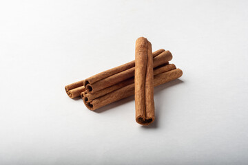 Cinnamon sticks on a white background for insulation. A few cinnamon sticks.