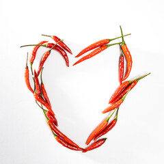 Fototapeta premium A lot of red hot miniature pepper in the circle isolated on white.