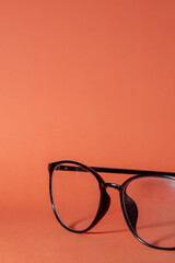 glasses on a orange table background