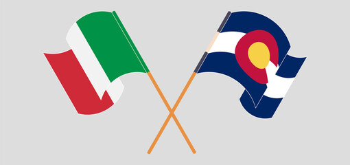 Crossed and waving flags of Italy and The State of Colorado