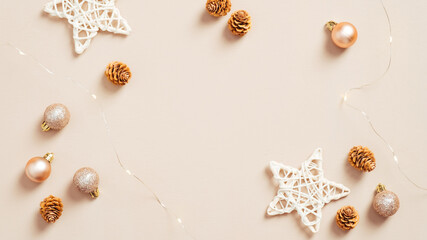 Fototapeta na wymiar Cozy Christmas decorations on pastel beige background. Flat lay, top view. Elegant Xmas background.