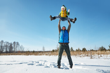 playing father and son in the winter outdoors - 394774695