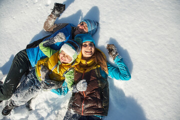 happy playing family in the winter. people outdoors - 394774803