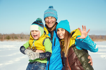 portrait of a happy happy family in the winter - 394775097