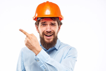 A man gestures with his hands an engineer orange hard hat safety construction
