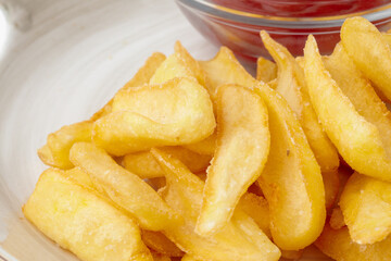 French fries with ketchup sauce on white plate