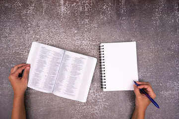 Bible Study and white notebook on a Old texture Table. Copy space text. Christian concept.