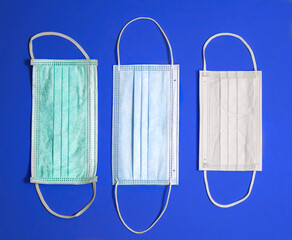 Surgical masks of different sizes on a blue background