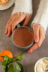 
Hot chocolate  in woman hand and sweater
