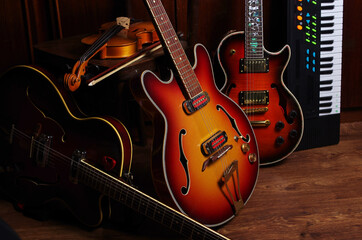 Three jazz electric guitars, violin and keyboard synthesizer in the interior
