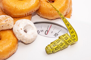 measuring tape with sweets and weighing scale