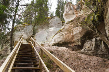 Fototapeta na wymiar Sandstone cliffs with a wooden trail - tourism, Gaujas National park, Latvia