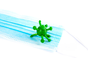 Coronavirus on a medical mask. Pandemic control concept. Protection against COVID-19.