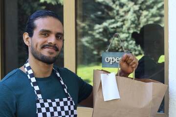 Waiter holding to go paper bag with receipt