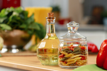 Glass jar of dry pasta on kitchen counter