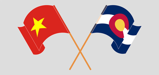 Crossed and waving flags of Vietnam and The State of Colorado
